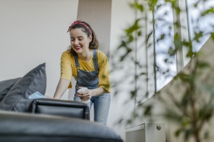 woman cleaning couch