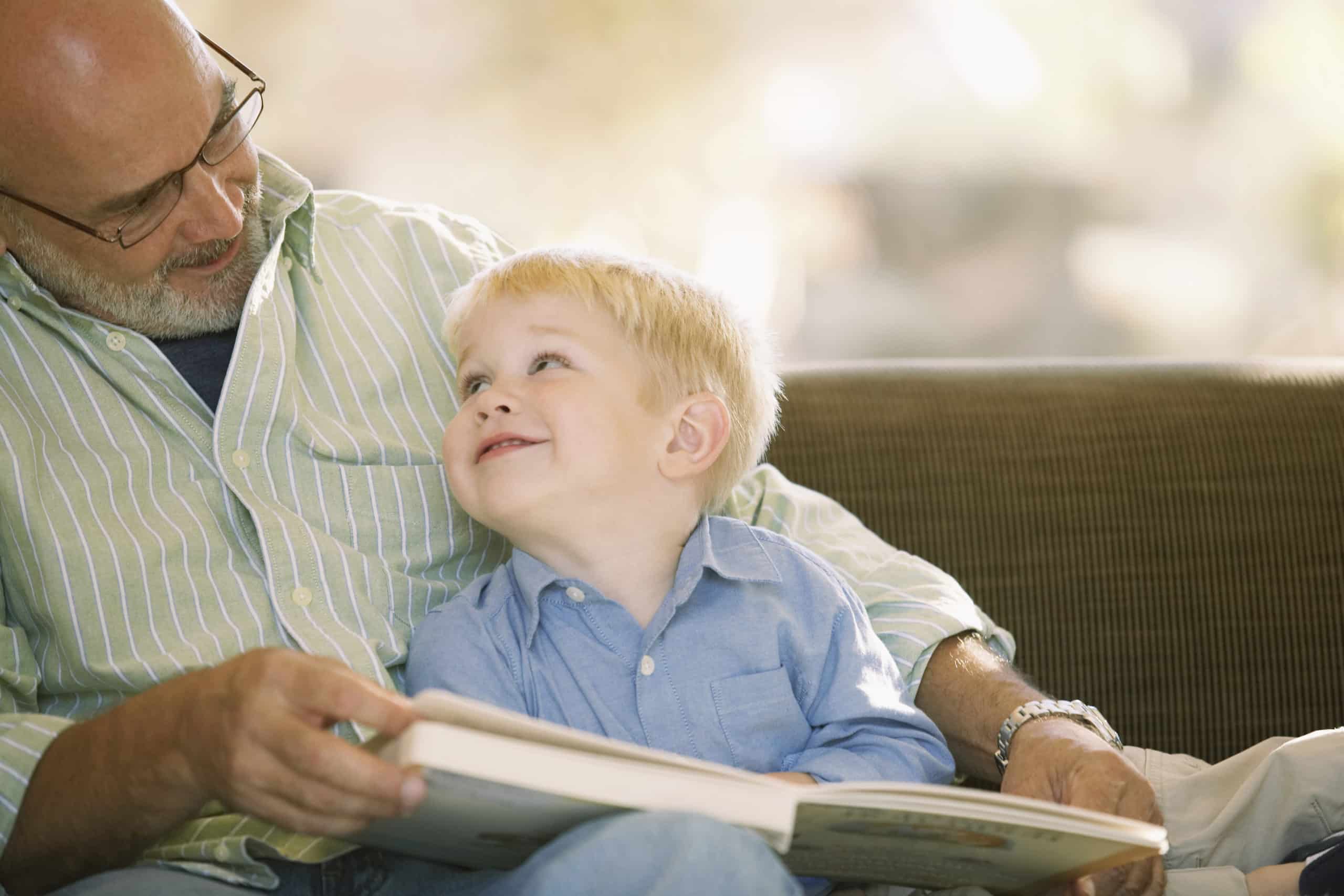 Grandfather reading with his grandson