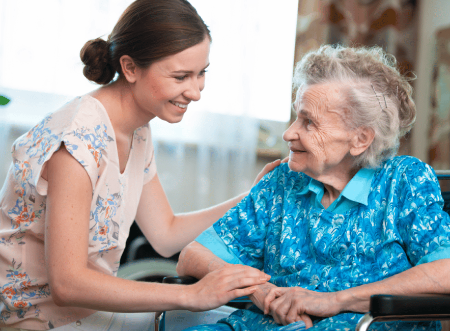 Senior resident being comforted by younger relative