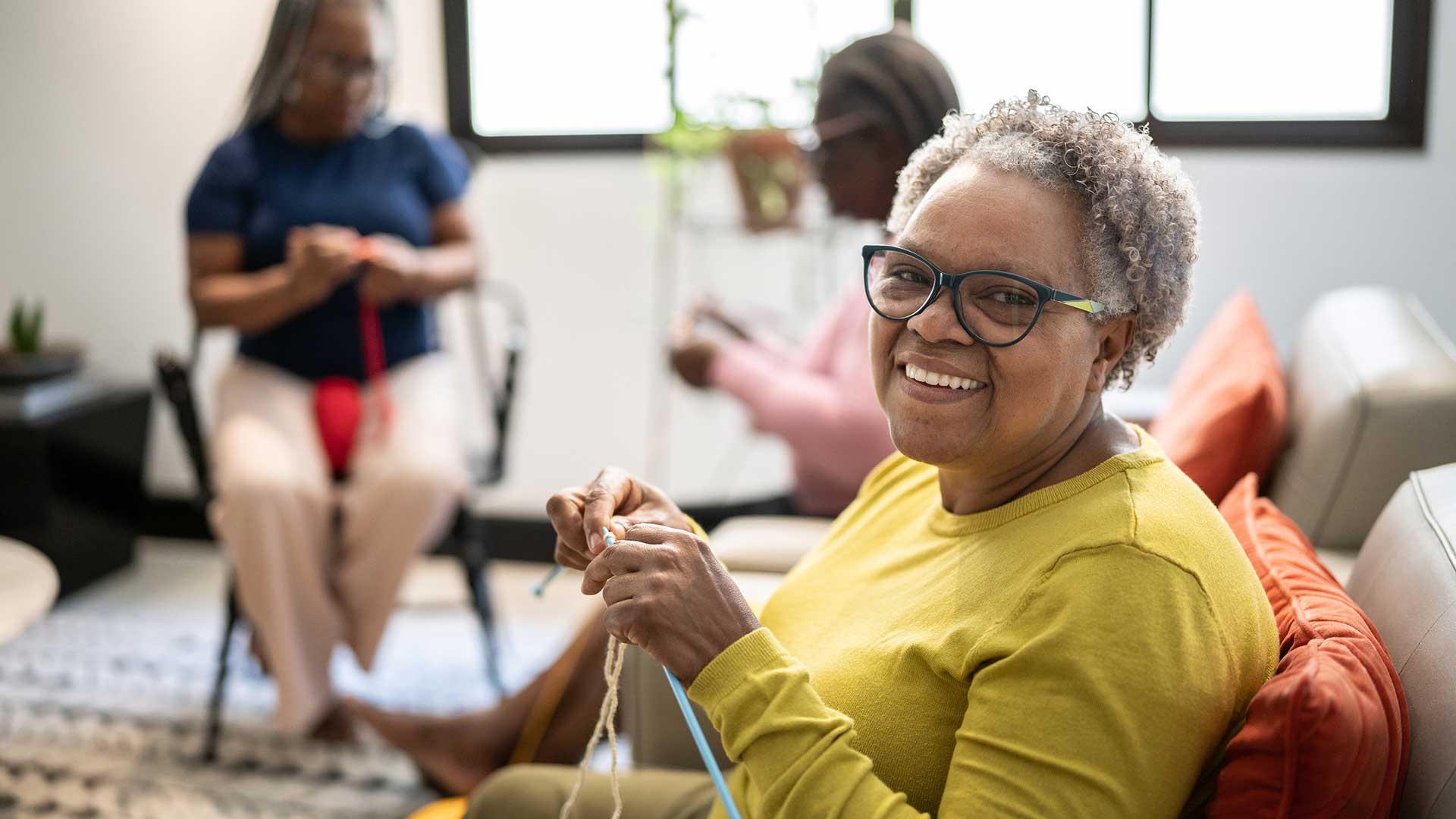 Portrait of a senior woman knitting at home